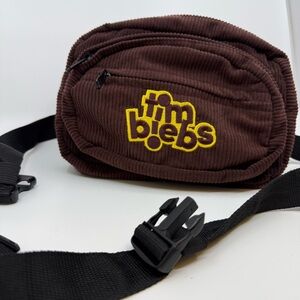 Justin Bieber Chocolate Crossbody Bag with Vibrant Yellow Logo